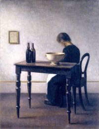 Vilhelm Hammersh I Interieur mit einer Frau, die an einem Tisch sitzt, 1910