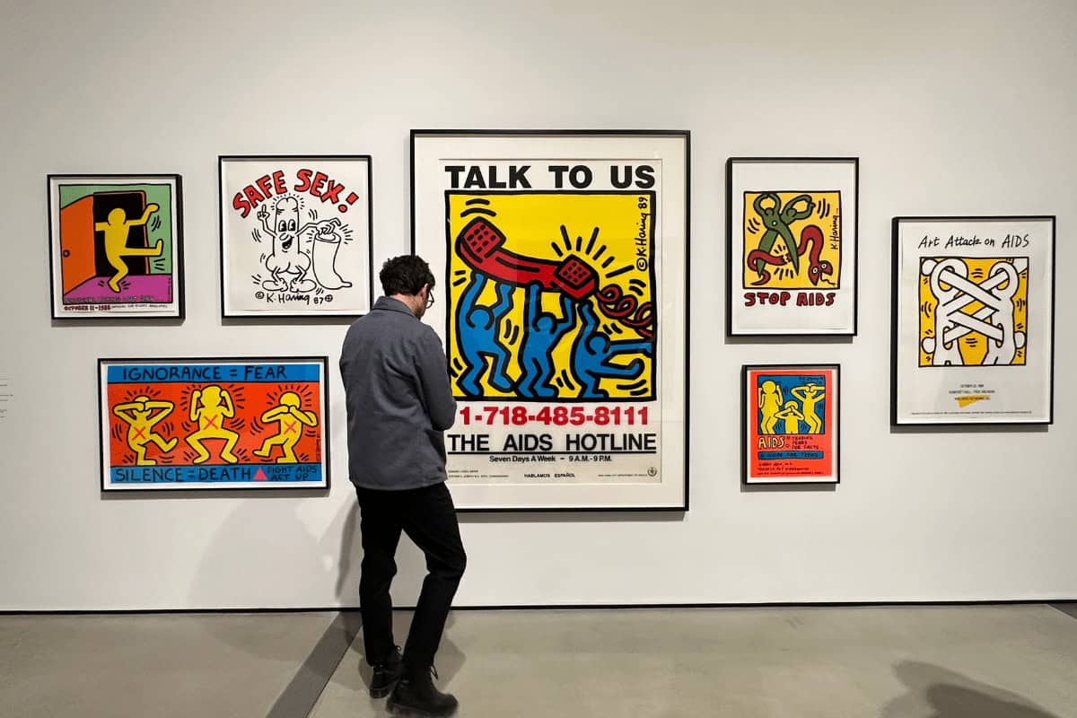 Vibrant Keith Haring-style artwork displayed in an art gallery setting.